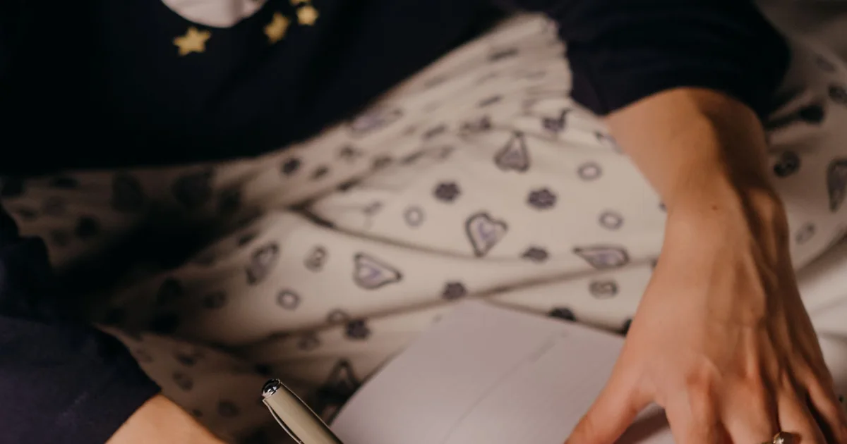 A person writing notes in a notebook