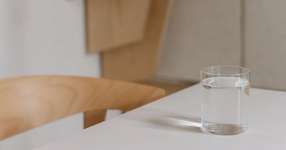 A glass of water on a wooden table